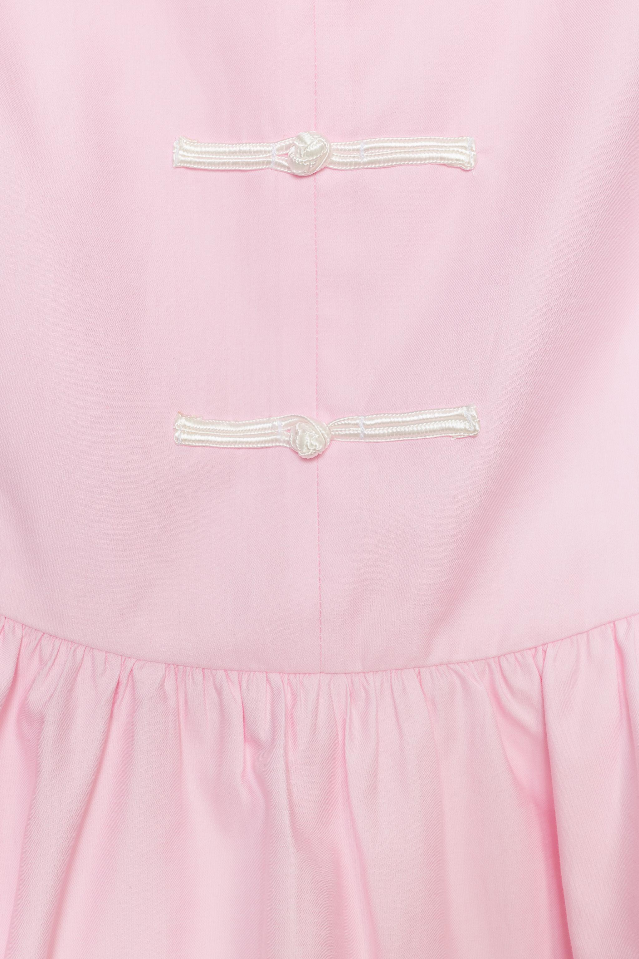 PEPLUM TOP WITH FIREMAN CLASPS